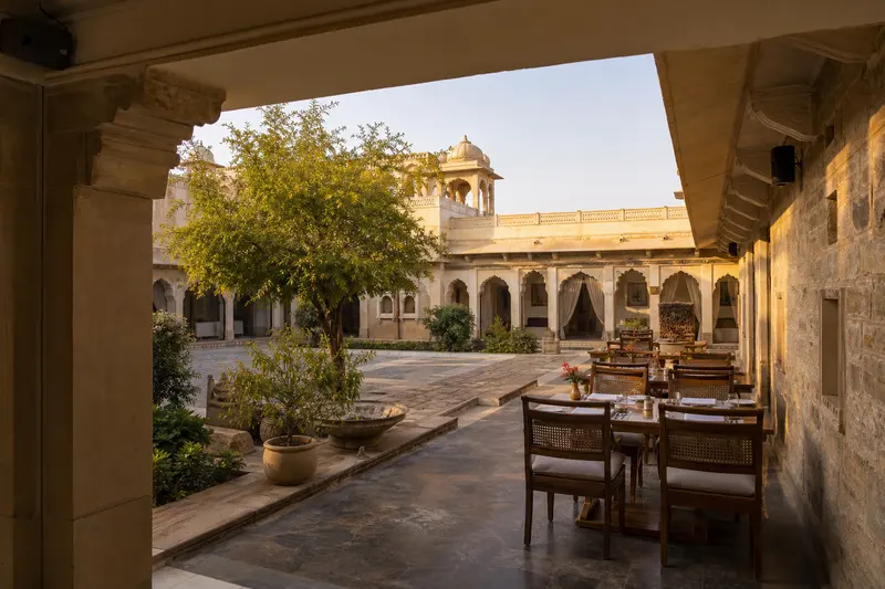 Heritage courtyard dining zones served by discreet weather-protected loudspeakers.