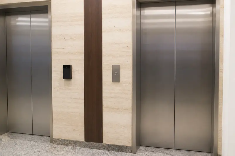 Office lift lobby with separate access reader and conventional call control.