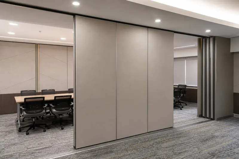 Motorized acoustic sliding partition divides a flexible commercial room.