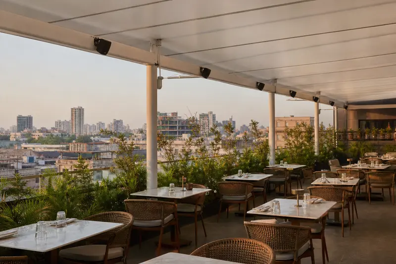 Zoned rooftop-restaurant audio under canopy.