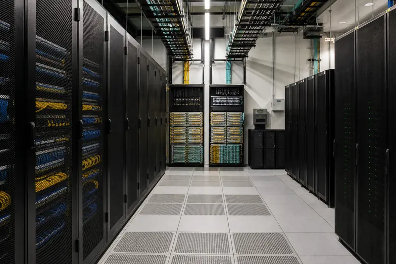 Large hotel network core with redundant racks and overhead fibre paths.