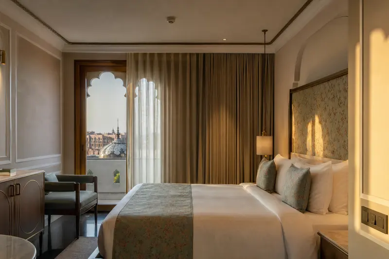 Jaipur suite with layered automated curtains and bedside master switches.