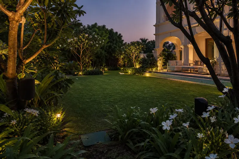 Weather-resistant landscape speakers cover an Indian villa garden and seating terrace.