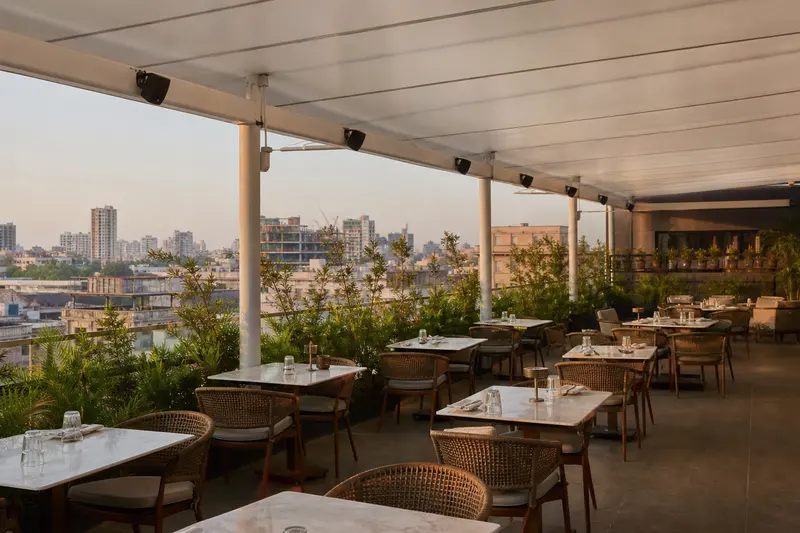 Zoned rooftop-restaurant audio under canopy.