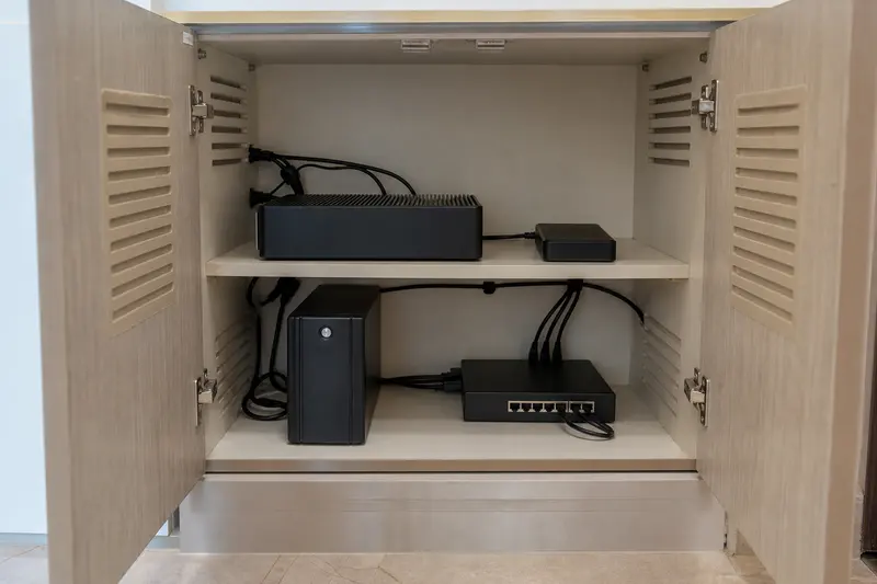 Resilient local automation hardware and backup sit on separated ventilated shelves.