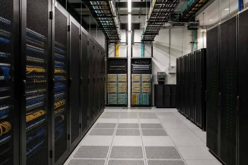 Large hotel network core with redundant racks and overhead fibre paths.