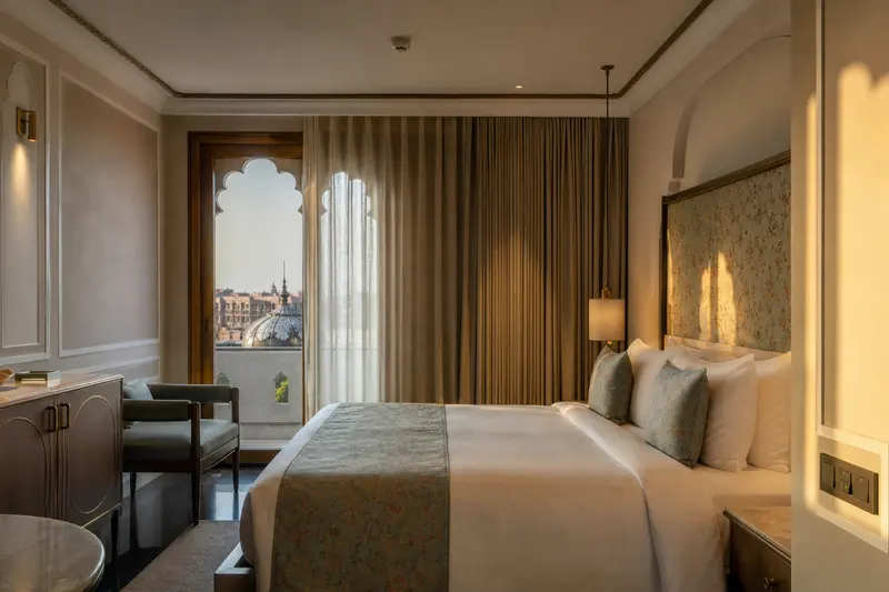 Jaipur suite with layered automated curtains and bedside master switches.