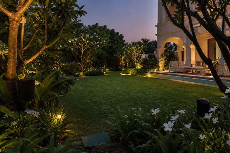 Weather-resistant landscape speakers cover an Indian villa garden and seating terrace.