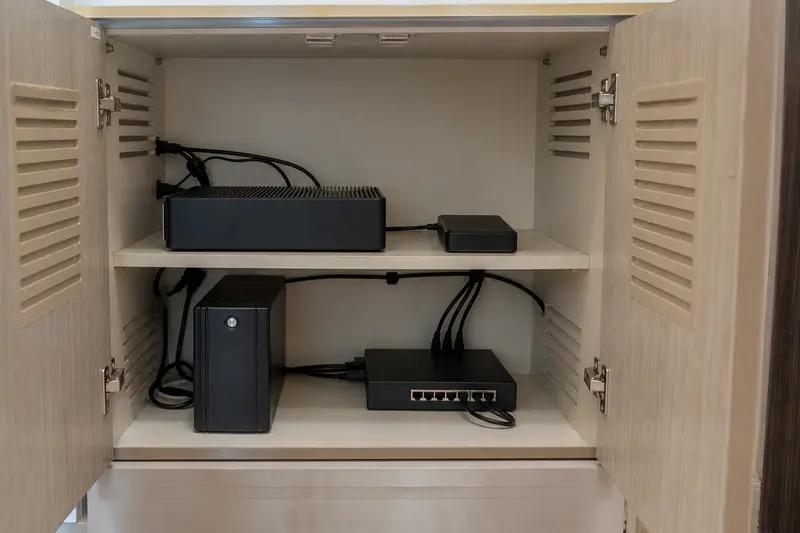 Resilient local automation hardware and backup sit on separated ventilated shelves.