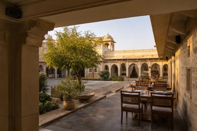Heritage courtyard dining zones served by discreet weather-protected loudspeakers.