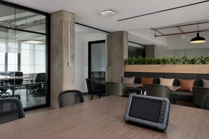 Blank RF survey instrument in an office with glass, concrete and a ceiling access point.